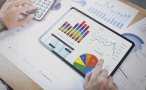 businesswoman using a tablet to analysis graph company finance strategy statistics success concept and planning for future in office room